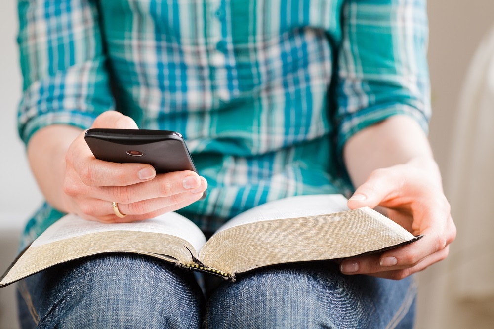 leer-desde-smartphone persona leyendo movil y libro